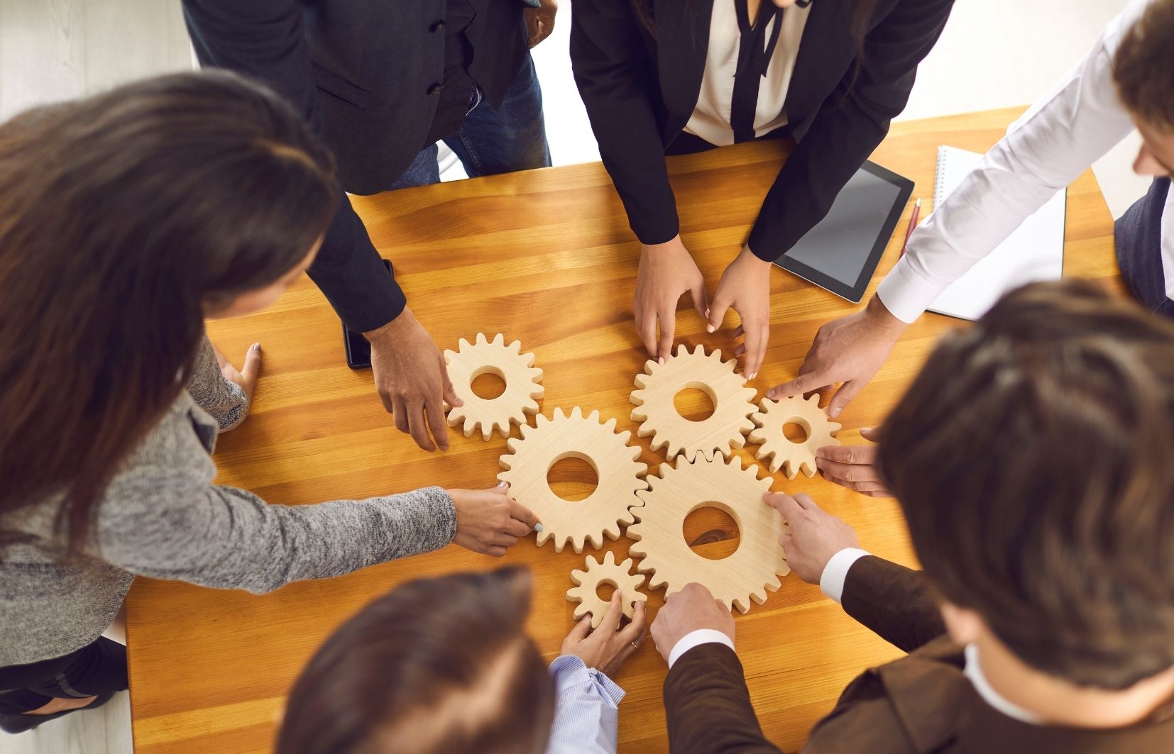 Imagem ilustrando pessoas gerindo ferramentas, representando estratégias para lucrar com arbitragem esportiva